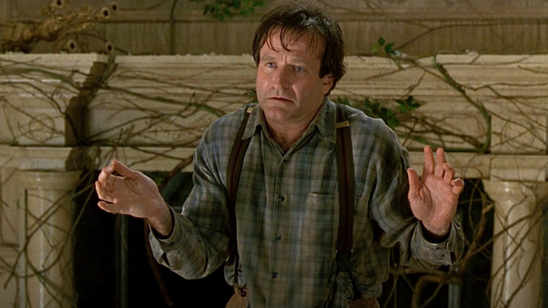 Robin Williams as Alan Perrish holds up his hands in Jumanji