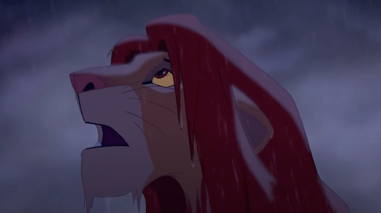 Matthew Broderick as Simba looks up in the rain in The Lion King