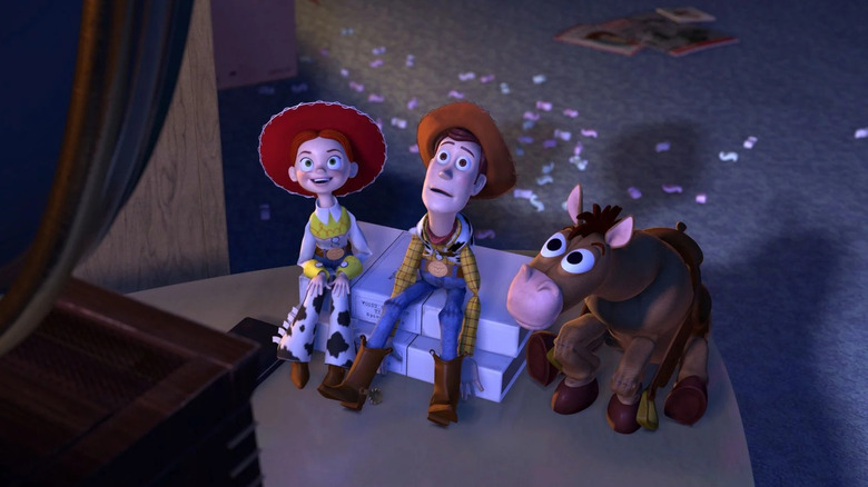 Joan Cusack as Jessie watches TV with Tom Hanks as Woody and Bullseye in Toy Story 2