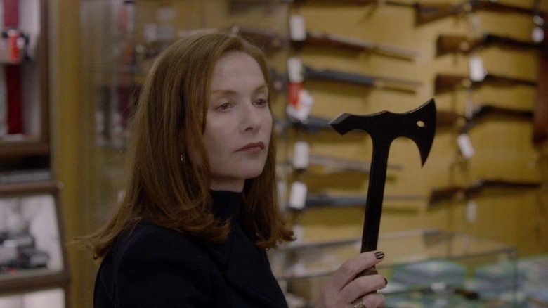 Michèle Leblanc holds a small axe in Elle (2016)