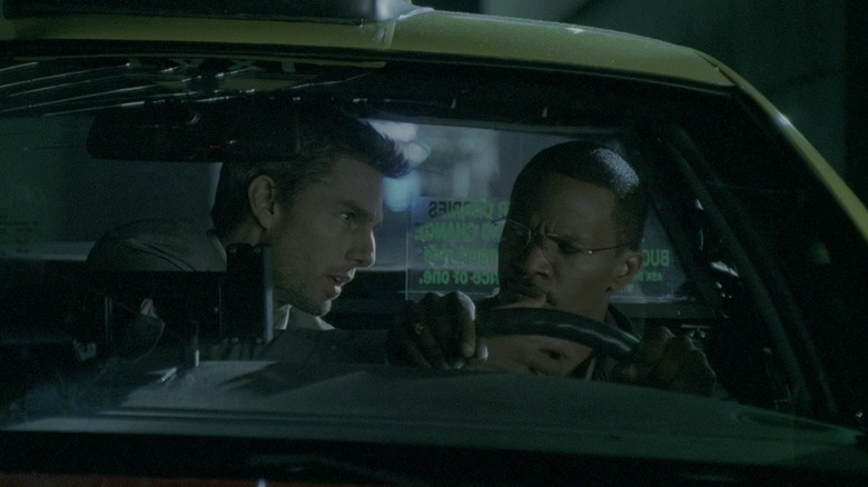 Tom Cruise and Jamie Foxx as Vincent and Max, sitting together in a taxi cab in Collateral