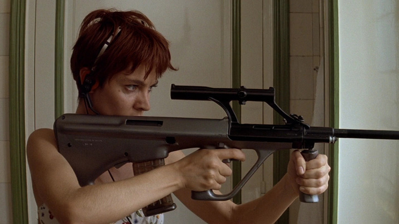 Anne Parillaud as Nikita, aiming a gun in La Femme Nikita