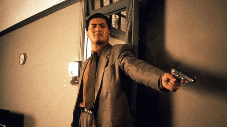 Chow Yun-fat as Ah Jong, aiming a pistol in The Killer (1989)