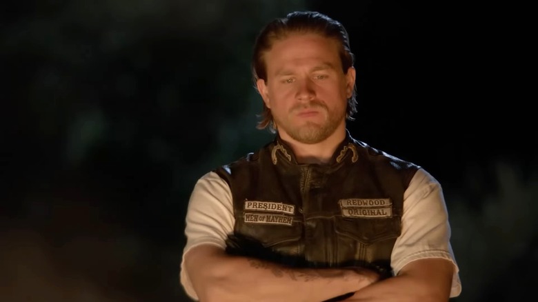 Charlie Hunnam as Jax Teller staring at the flames in Sons of Anarchy