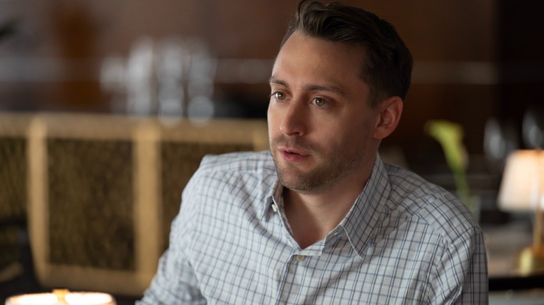 Kieran Culkin as Roman Roy looking across the table in Succession