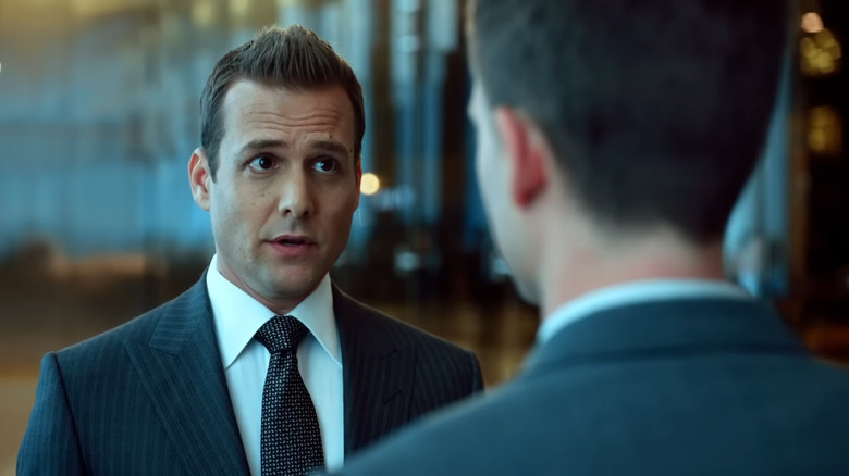 Gabriel Macht's Harvey Specter looking at Patrick J. Adams' Mike Ross in Suits