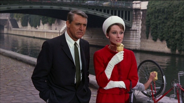 Cary Grant Audrey Hepburn walking along Seine