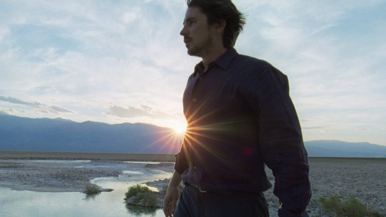 Christian Bale walking on the beach Knight of Cups