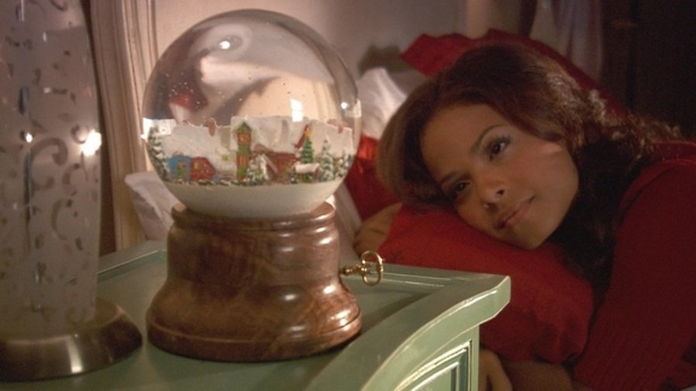 Angela staring at snowglobe