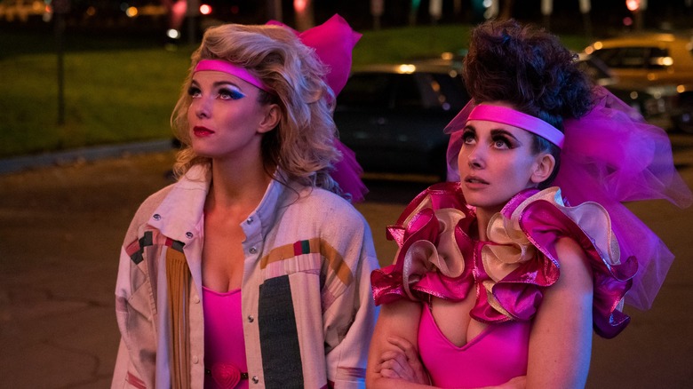 Betty Gilpin and Alison Brie wearing wrestling gear  in GLOW