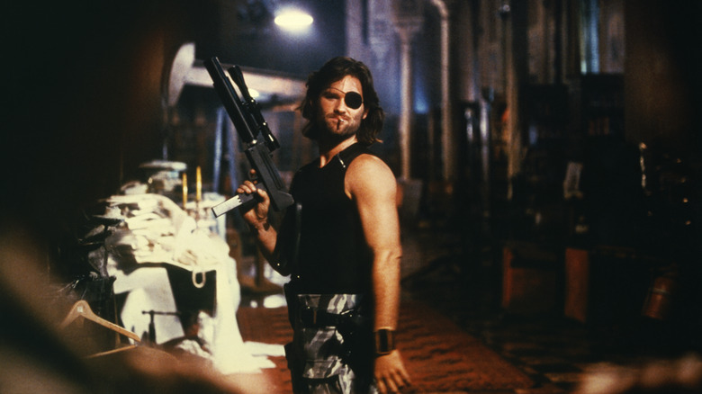 Snake Plissken holds weapon