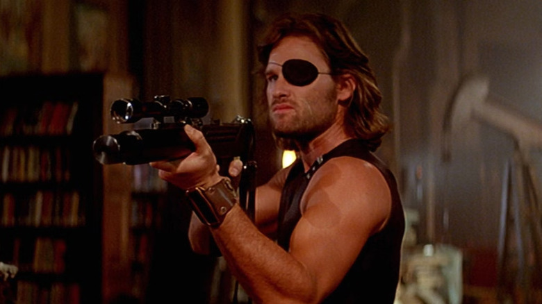 Snake Plissken holds weapon