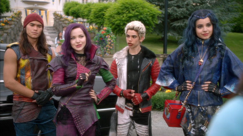 Jay (Booboo Stewart), Mal (Dove Cameron), Carlos (Cameron Boyce), and Evie (Sofia Garson) arrive at school in Descendants