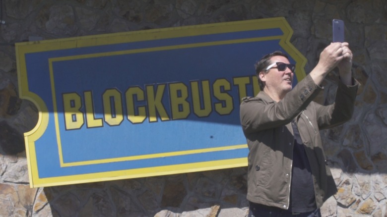 Doug Benson takes a selfie outside of The Last Blockbuster