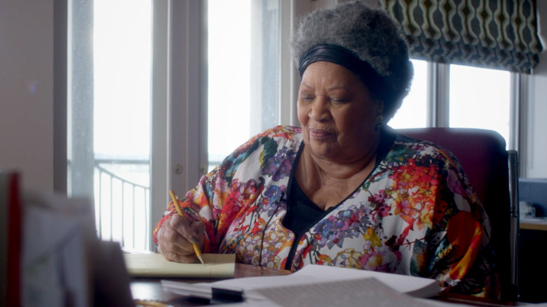 Toni Morrison writing at her desk