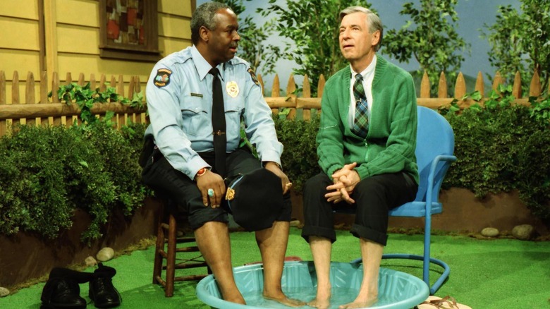 Fred Rogers and police officer share a paddling pool