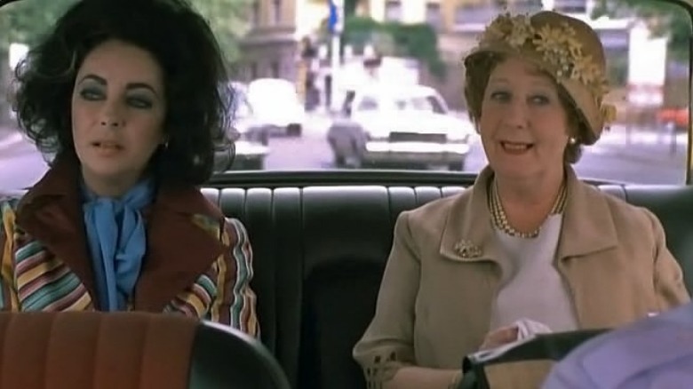 Elizabeth Taylor rides in the back of a taxi 
