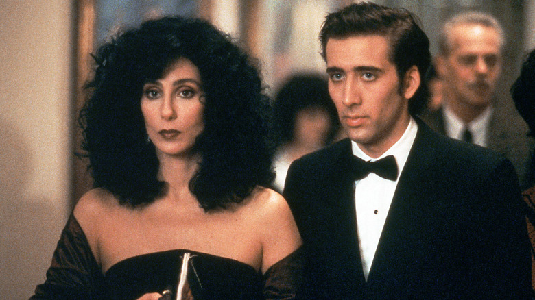 Loretta and Ronny dressed up and looking serious in Moonstruck