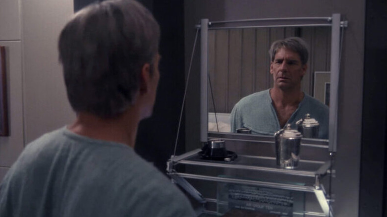 An older Archer (Scott Bakula) looks at himself in a mirror in Star Trek: Enterprise