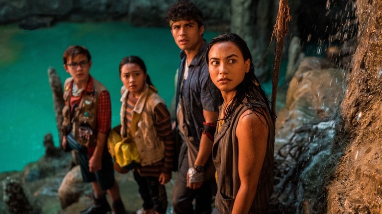 Four kids stand on a cliffside, looking at something offscreen