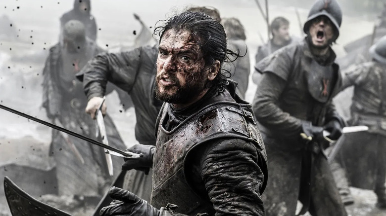 Kit Harrington as Jon Snow, fighting in a battle on Game of Thrones