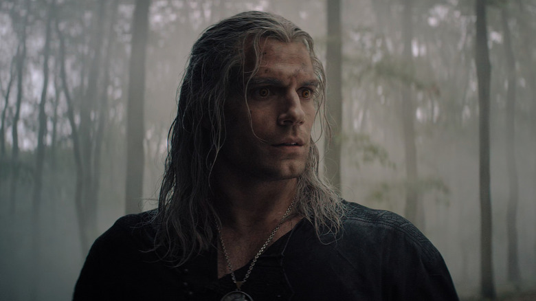 Henry Cavill as Geralt of Rivera in the woods in Netflix's The Witcher