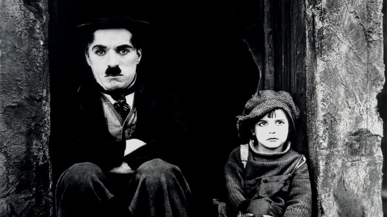 Chaplin and Coogan sitting on stoop