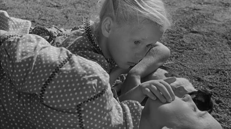 Girl touches father's face