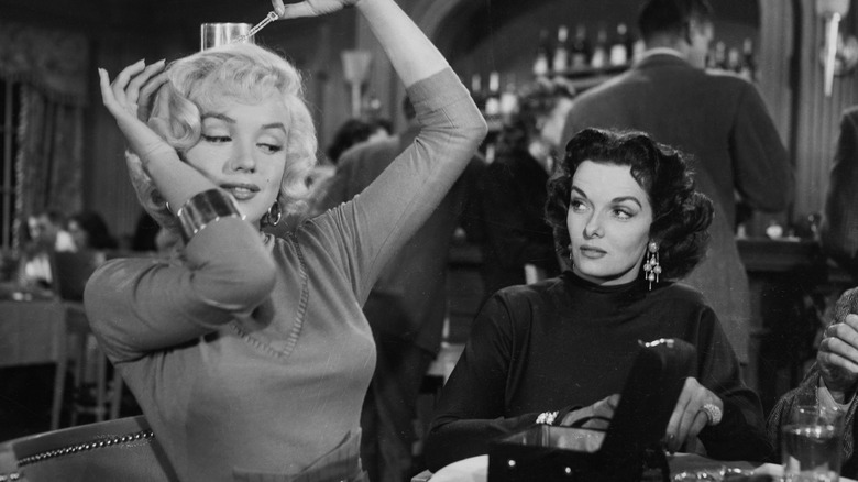 Marilyn Monroe putting on jewels with Jane Russell