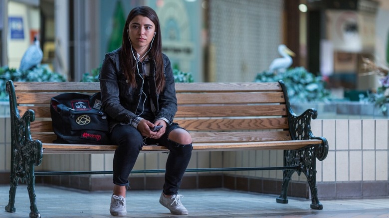 A girl sits on a bench