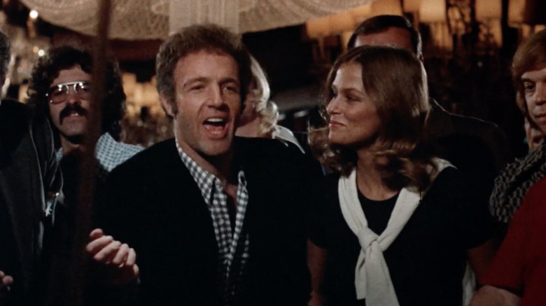 James Caan as Axel Freed celebrates next to Lauren Hutton as Billie in The Gambler