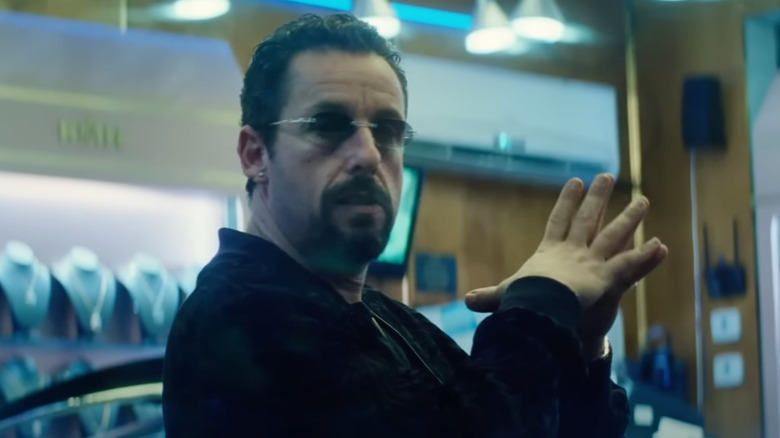 Adam Sandler as Howard holds his fingers together in Uncut Gems