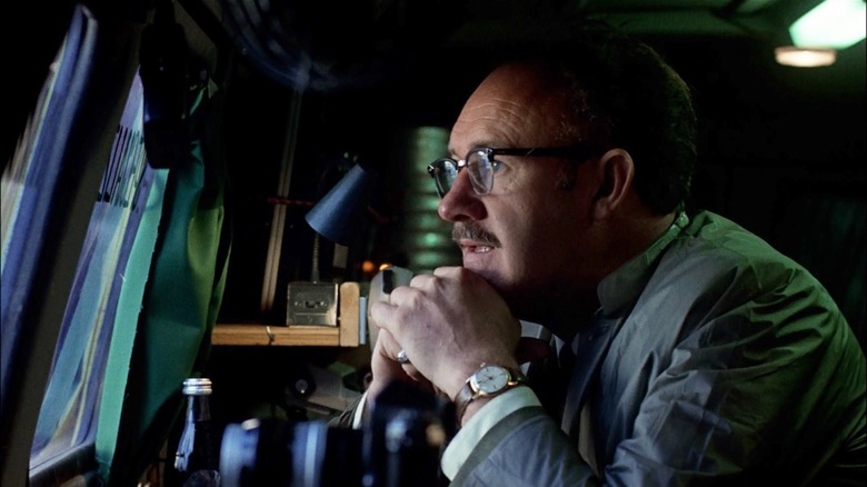 Gene Hackman watching closely