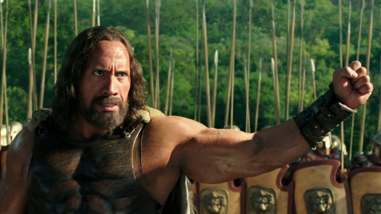 The Rock as Hercules, fist raised in front of an army