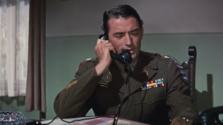 Peck in military uniform on phone