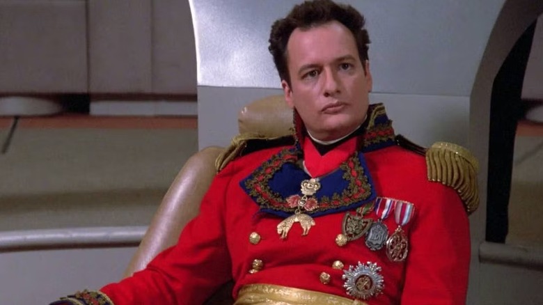 Q (John de Lancie) sits on the Enterprise bridge in Napoleonic gear on Star Trek: The Next Generation