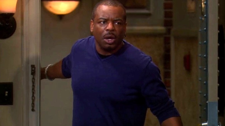 LeVar Burton as himself has a shocked expression as he opens the door to Sheldon Cooper and Leonard Hofstadter's apartment on The Big Bang Theory