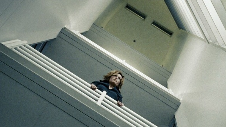 Untraceable Jennifer looks down a balcony