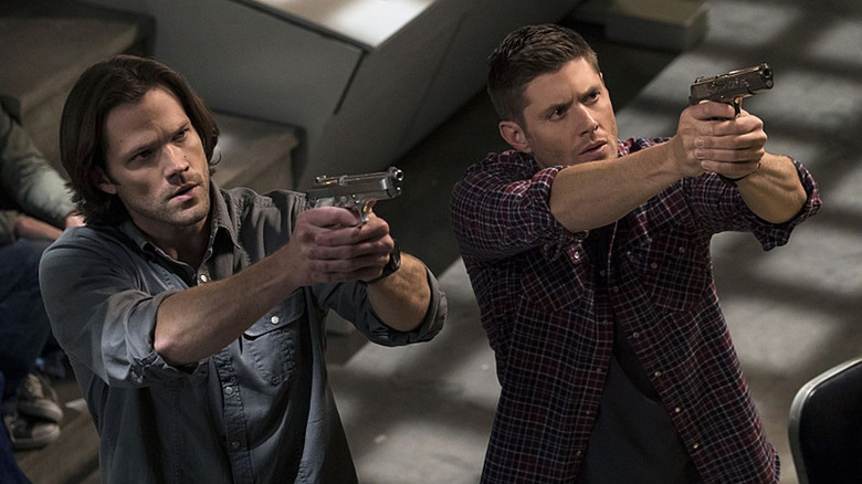 Sam and Dean point guns in Supernatural