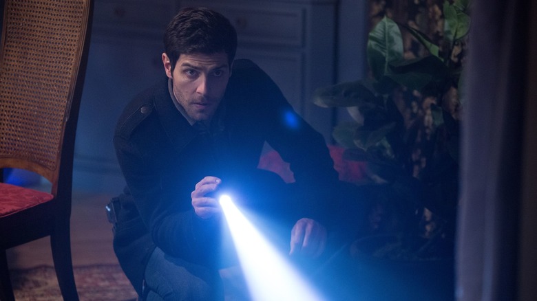 Grimm's Nick shines a flashlight