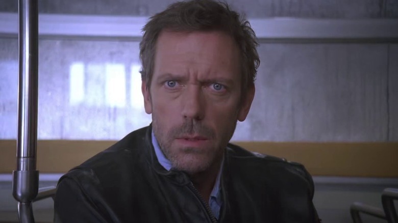 Hugh Laurie as Dr. Gregory House sitting on a bus on House