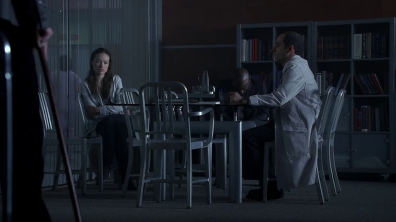 Olivia Wilde as Dr. Remy "Thirteen" Hadley, Omar Epps as Dr. Eric Foreman, and Peter Jacobson as Dr. Christopher Taub in a common area in House