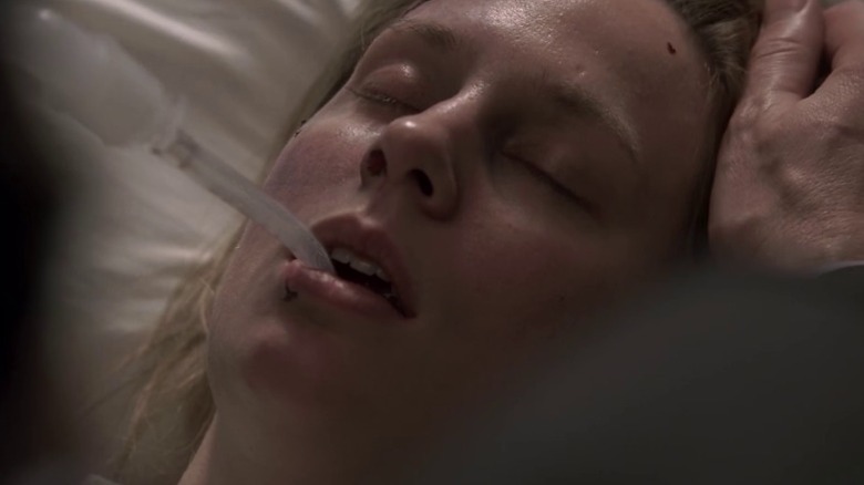 Anne Dudek as Dr. Amber Volakis looking sick with a tube in her mouth on House