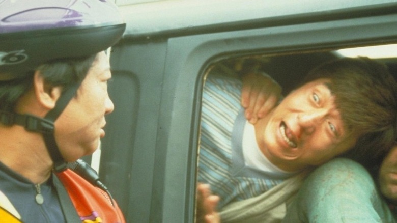 Jackie Chan makes face in van