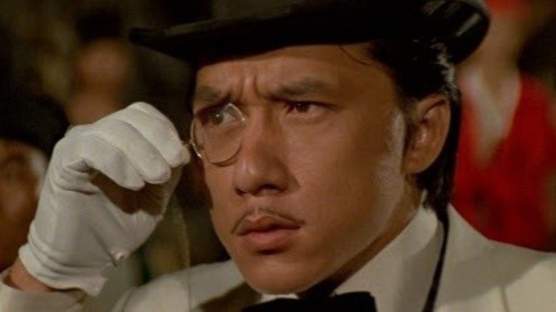 Jackie Chan moustache looks through monocle