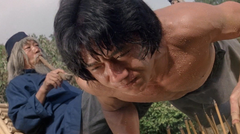 Jackie Chan strains as he trains with a wise master in Snake in the Eagle's Shadow