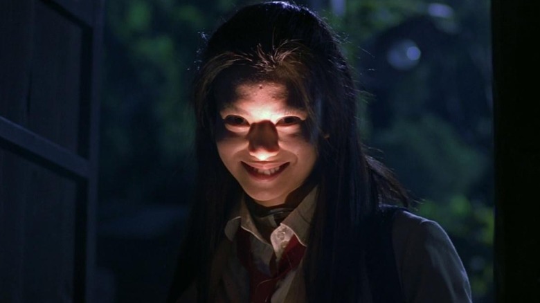 Ko Shibasaki smiling with flashlight raised to chin