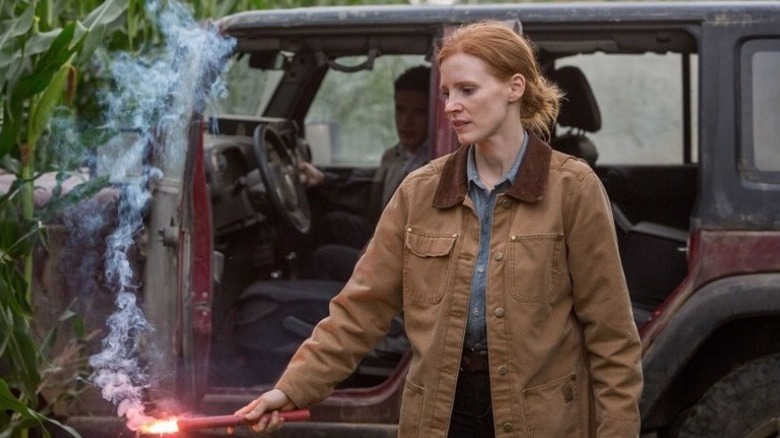 chastain holding smoking flare