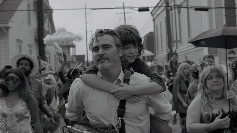 Joaquin Phoenix carries Woody Norman