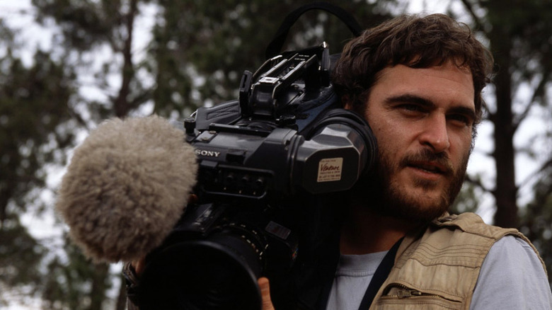 Joaquin Phoenix carries camera